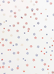 4th of July American Independence Day blue and red stars decorations on white   background. Flat lay, top view, copy space.Red and blue stars border for American Independence 