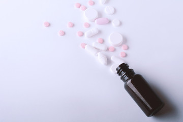 Fototapeta na wymiar Close up of heap of pills with pill bottle