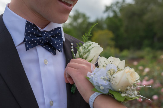 pinning boutonniere and corsage for prom or formal