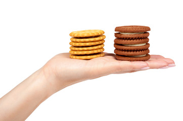 Hand with cookies with cream filling isolated on white background.