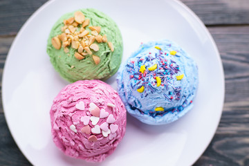 Assorted ice cream scoops on plate, summer seasonal sweets, cold refreshing dessert close up.