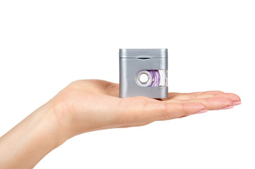 Dental floss in grey container with hand isolated on white background.