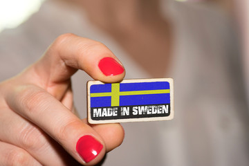 Eine Frau und ein Schild mit dem Slogan Made In Sweden