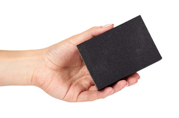 Black sand abrasive bar with hand isolated on white background.