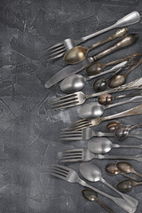 Vintage silverware on dark grey