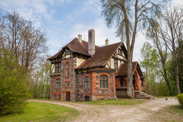 Stone house in Estonia, manor building decorated with granite. Summer time.