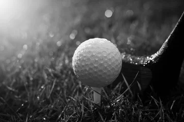 Fotobehang Golf clubs and golf balls are wet with warm light rain at sunset © khampiranon