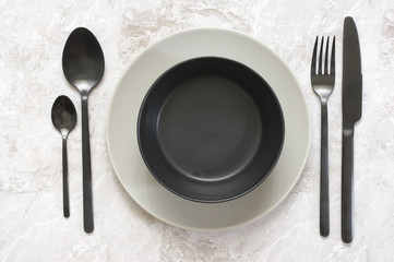 Black and white tableware on marble