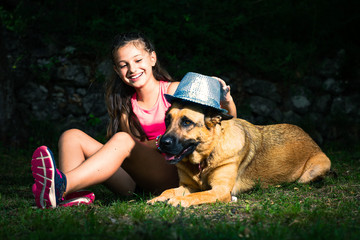 A little girl plays with her German shepherd dog