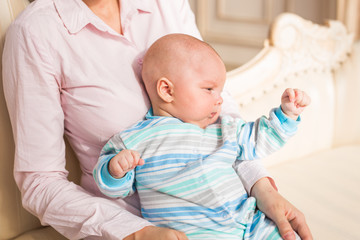 Mother holding adorable baby son