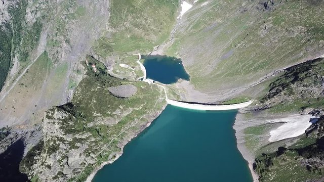 Up and down drone aerial view of the Lake Barbellino an alpine artificial lake. Italian Alps. Italy