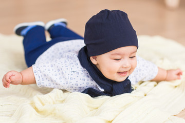 Adorable baby boy in sunny bedroom. Newborn child relaxing