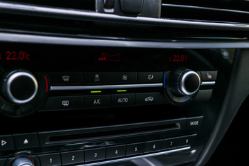 Air conditioning button inside a car. Climate control AC unit in the new car. Modern car interior...