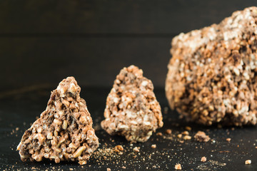 Three pieces of chocolate mix with puffed rice and raisins