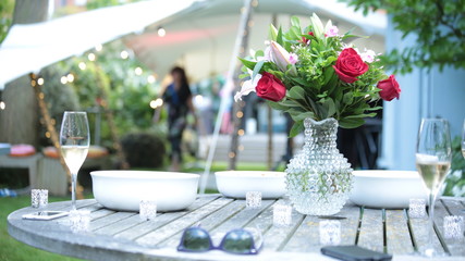 Table with flowers & champagne at a garden party