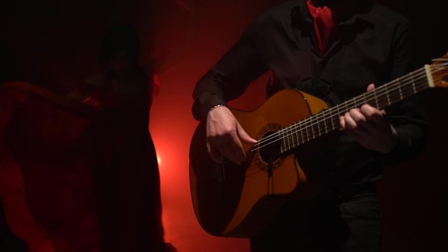 Girl dancing flamenco dance. Light from behind. smoke background