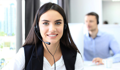 Attractive positive young businesspeople and colleagues in a call center office.