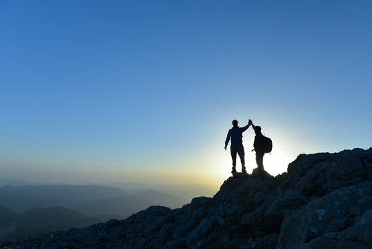 Couple hikers success concept in mountains
