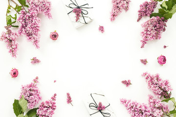 Lilac flowers, gift box, pion flowers on white background. Flat lay, top view