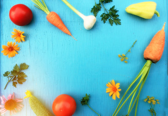 Fototapeta na wymiar Harvested vegetables (carrot, tomatoes, cucumber, pepper, parsley, young garlic): nutrient-rich foods concept, top view background with copy space