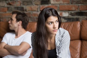 Angry unhappy young couple ignoring not looking at each other after family fight or quarrel, upset...
