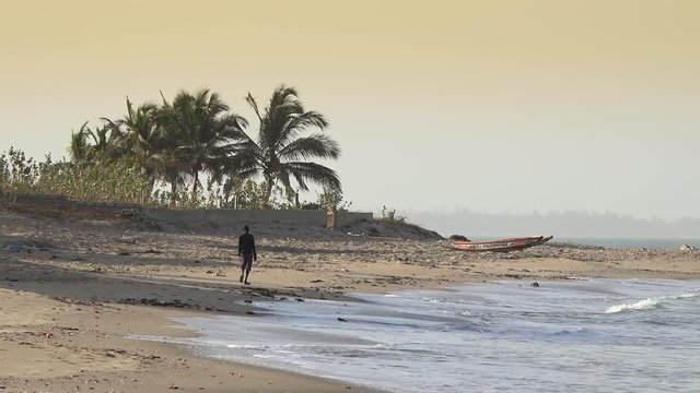 Black man walking in a African beach - African landscape