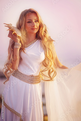 Beautiful Girl In A Long White Wedding Dress In Greek Style Is The