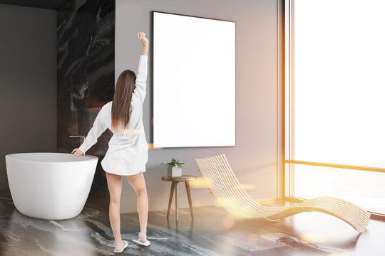 Gray luxury bathroom interior, tub and poster girl