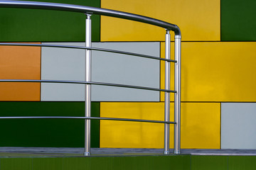 Steps and shoes from stainless steel on the background of a multi-colored fa ade of cubes