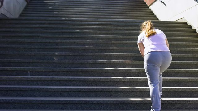 Hard to climb stairs for obese girl, victory over fatigue for goal achieving