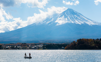 fuji mountain with fishing boat and shimmer of sunlight reflecion.