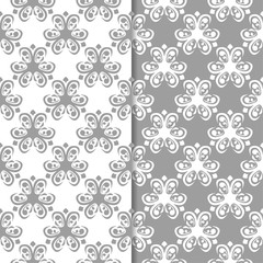 White and gray floral backgrounds. Set of seamless patterns