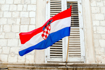 Croatian flag hanging on the background of an old building