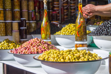 Olives and various spicy pickles in a large bowl on the shelves at the market in Marrakesh. Morocco. Africa