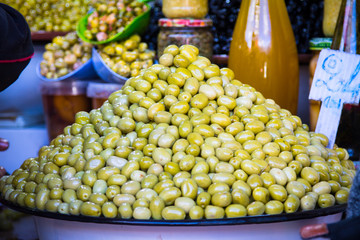 Olives and various spicy pickles in a large bowl on the shelves at the market in Marrakesh. Morocco. Africa