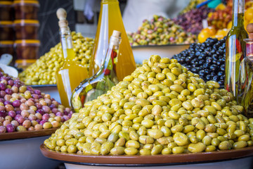 Olives and various spicy pickles in a large bowl on the shelves at the market in Marrakesh. Morocco. Africa