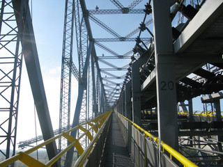 perspective construction detail of bucket wheel excavator in front, landscape and cloudy sky, East Germany, energy industry in Lusatia