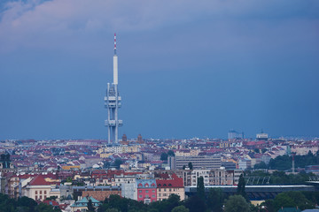 Landscape or cityscape Picture of Prague television tower in Zizkov quarter taken in summer evening before storm with heavy dark blue clouds. Modern prague architecture. 