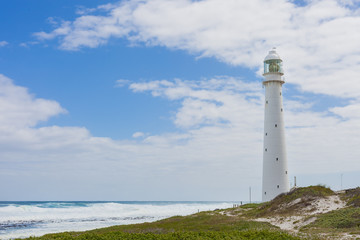 Fototapeta na wymiar Lighthouse on a rugged coastline during the daytime