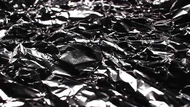 Aluminium foil rotating pattern macro texture background backdrop footage video.