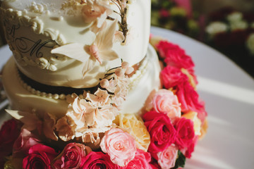 Tasty big wedding cake decorated with roses