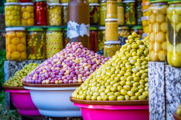 Olives and various spicy pickles in a large bowl on the shelves at the market in Marrakesh. Morocco. Africa