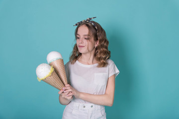 Playful teen girl have fun with big hand made ice cream. Blue, aqua background, isolated.