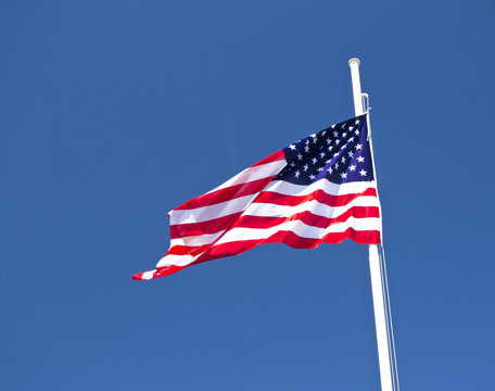 usa flag waving in the wind with blue sky as background
