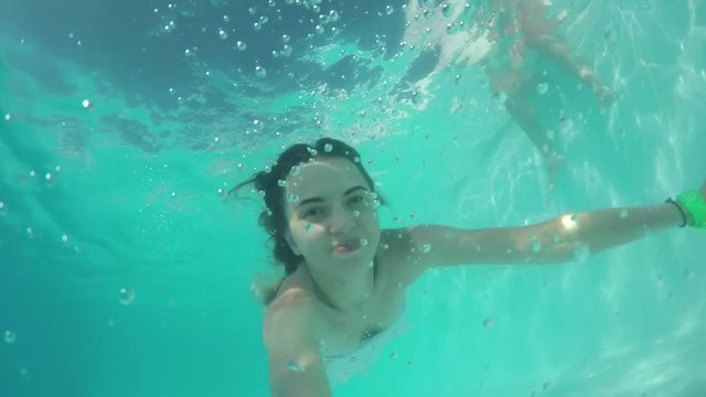 Girl In Swimming Pool And Swim Underwater