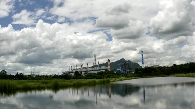 Time Lapse of White fluffy clouds in the blue sky and Power plant background