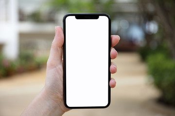 female hand holding phone with isolated screen on nature background