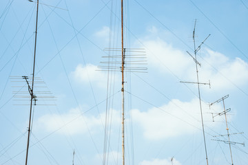 many television antenna with blue sky