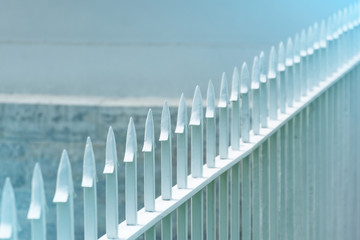 The sharp tip of the metal fence of the fence row.