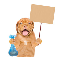 puppy holds plastic bag and placard. Concept cleaning up dog droppings. isolated on white background